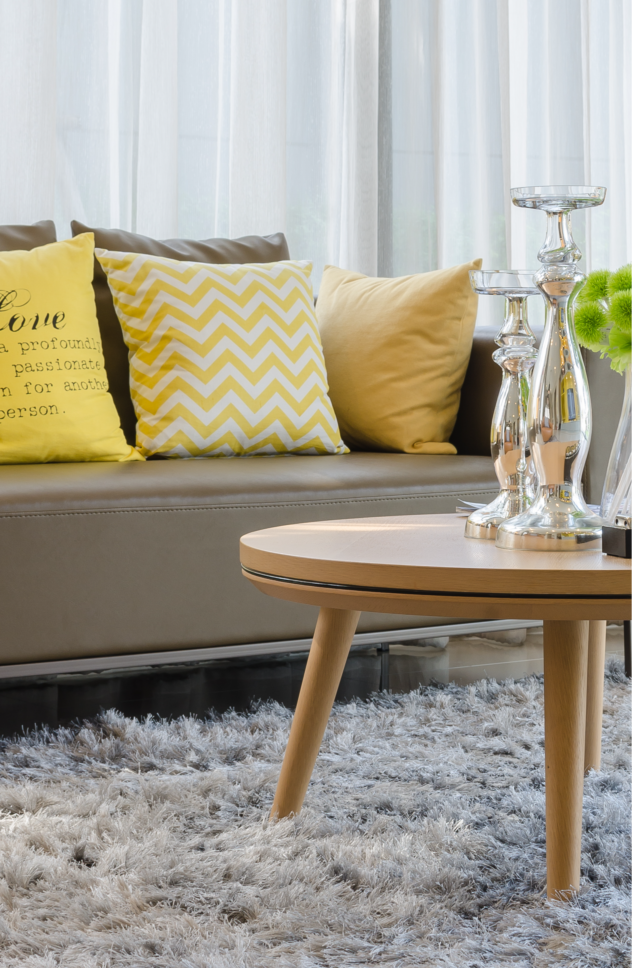 Home upgrades on a budget are possible! Consider using oversized pillows to add a more plush look to your living room.