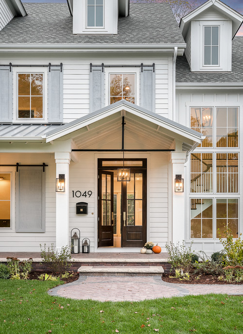 Modern White Farmhouse Exterior with Gray Barn Door Shutters