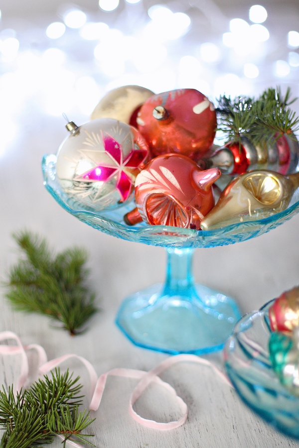 A glass candy bowl with ornaments is so cute and you can easily make it look rustic. For fun farmhouse Christmas decor ideas, look here.